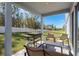 Relaxing covered patio with seating and grill at 1109 Catskill Dr, Haines City, FL 33844