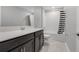 Bathroom with dark brown vanity and shower/tub combo at 136 White Horse Way, Groveland, FL 34736