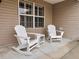 Inviting patio with white rocking chairs and side table at 1605 Alhambra Way, The Villages, FL 32162