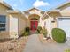 Inviting front entry with a red door and pathway at 17342 Se 80Th Biltmore Ave, The Villages, FL 32162