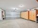 Garage with built-in storage cabinets and ample space for parking at 17342 Se 80Th Biltmore Ave, The Villages, FL 32162