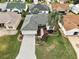 Aerial view of a house with a landscaped yard and paver driveway at 17640 Se 81St Timberwood Ter, The Villages, FL 32162