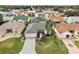 Aerial view of a house with a landscaped yard and paver driveway at 17640 Se 81St Timberwood Ter, The Villages, FL 32162