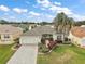Aerial view of a house with a landscaped yard and paver driveway at 17640 Se 81St Timberwood Ter, The Villages, FL 32162