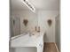 Bathroom with double vanity, large mirror, and shower at 17640 Se 81St Timberwood Ter, The Villages, FL 32162