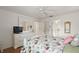 Bedroom with floral bedding, dresser and en-suite bathroom at 17640 Se 81St Timberwood Ter, The Villages, FL 32162