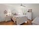 Bedroom with floral bedding, wood floors and white dresser at 17640 Se 81St Timberwood Ter, The Villages, FL 32162