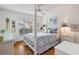 Charming bedroom with a post bed, hardwood floors, and window at 17640 Se 81St Timberwood Ter, The Villages, FL 32162