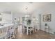 Kitchen and dining area with white cabinets and a glass-top table at 17640 Se 81St Timberwood Ter, The Villages, FL 32162