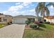Single-story home with a paved driveway and landscaped yard at 17640 Se 81St Timberwood Ter, The Villages, FL 32162