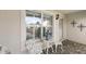 Quaint front porch with white chairs and small table at 17640 Se 81St Timberwood Ter, The Villages, FL 32162