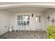 Front porch with white metal chairs and a table at 17640 Se 81St Timberwood Ter, The Villages, FL 32162