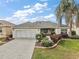 Attractive house exterior with a landscaped yard and paver driveway at 17640 Se 81St Timberwood Ter, The Villages, FL 32162