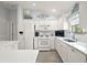 Modern kitchen with white cabinets, stainless steel appliances and ample counter space at 17640 Se 81St Timberwood Ter, The Villages, FL 32162