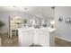 White kitchen island with cabinets and a large countertop at 17640 Se 81St Timberwood Ter, The Villages, FL 32162