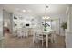 Open kitchen with white cabinets, island, and breakfast bar at 17640 Se 81St Timberwood Ter, The Villages, FL 32162