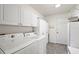 Bright laundry room with washer, dryer, and ample storage at 17640 Se 81St Timberwood Ter, The Villages, FL 32162