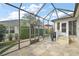 Spacious screened patio with flagstone flooring, access to the house and a grill at 17640 Se 81St Timberwood Ter, The Villages, FL 32162