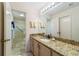 Clean bathroom, granite vanity, and a shower/tub combo at 2001 Castano Pl, The Villages, FL 32159