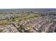 Wide aerial view of community near golf course with various homes at 2243 Montbrook Pl, The Villages, FL 32162