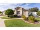 Single-story house with a landscaped yard and walkway at 2243 Montbrook Pl, The Villages, FL 32162