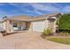 Single-story home with a two-car garage and landscaped yard at 2243 Montbrook Pl, The Villages, FL 32162