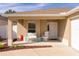 Front porch with seating and a two-car garage at 2243 Montbrook Pl, The Villages, FL 32162