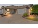 Well-lit single-story home with a two-car garage and landscaped yard at 2243 Montbrook Pl, The Villages, FL 32162
