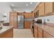 Modern kitchen with stainless steel appliances and light wood cabinets at 2243 Montbrook Pl, The Villages, FL 32162