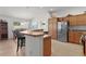 Kitchen features breakfast bar, stainless steel appliances, and ample cabinet space at 2243 Montbrook Pl, The Villages, FL 32162