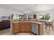 Island kitchen with stainless steel appliances and a breakfast bar at 2243 Montbrook Pl, The Villages, FL 32162