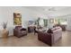 Spacious living room with leather furniture and hardwood floors at 2243 Montbrook Pl, The Villages, FL 32162