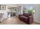 Living room with access to a lanai and hardwood floors at 2243 Montbrook Pl, The Villages, FL 32162