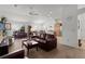 Bright living room with hardwood floors and open view to kitchen and dining area at 2243 Montbrook Pl, The Villages, FL 32162