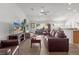 Spacious living room with leather furniture and hardwood floors at 2243 Montbrook Pl, The Villages, FL 32162