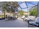 Screened patio with seating and table, great for relaxing at 2243 Montbrook Pl, The Villages, FL 32162