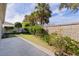 Landscaped side yard with concrete patio and lush greenery at 2243 Montbrook Pl, The Villages, FL 32162