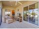 Sunroom features comfortable seating and views of the backyard at 2243 Montbrook Pl, The Villages, FL 32162