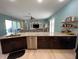 Kitchen with granite island, stainless steel appliances, and light flooring at 22531 5Th St, Howey In The Hills, FL 34737