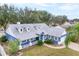 Attractive blue home with white trim, gray roof, and landscaped yard at 2709 Tremont Dr, Eustis, FL 32726