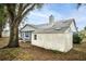 Home exterior showcasing a shed and large tree at 2709 Tremont Dr, Eustis, FL 32726