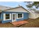 Home's back exterior with patio and detached shed at 2709 Tremont Dr, Eustis, FL 32726