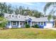 Charming one-story home with blue exterior, white trim, and a well-maintained lawn at 2709 Tremont Dr, Eustis, FL 32726