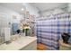 Bathroom with a shower/tub combo and updated fixtures at 27437 Desert Rose Ct, Leesburg, FL 34748
