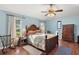Cozy bedroom with wooden flooring and a ceiling fan at 27437 Desert Rose Ct, Leesburg, FL 34748