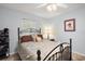 Well-lit bedroom with a full-size bed and ceiling fan at 27437 Desert Rose Ct, Leesburg, FL 34748