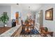 Formal dining room with wood table, chandelier, and area rug at 27437 Desert Rose Ct, Leesburg, FL 34748