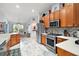 Modern kitchen with stainless steel appliances and wood cabinets at 27437 Desert Rose Ct, Leesburg, FL 34748