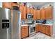 Modern kitchen with stainless steel appliances and ample wood cabinetry at 27437 Desert Rose Ct, Leesburg, FL 34748