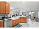 Spacious kitchen with light wood cabinets, stainless steel appliances, and white countertops at 27437 Desert Rose Ct, Leesburg, FL 34748